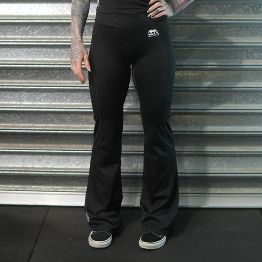 Black flared athletic pants with Dead Tide skull logo and dagger print – alternative gymwear by Dead Tide