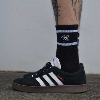  Black athletic socks with skull graphic and Dead Tide branding – edgy sports sock